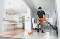 man vacuuming water to prevent water damage